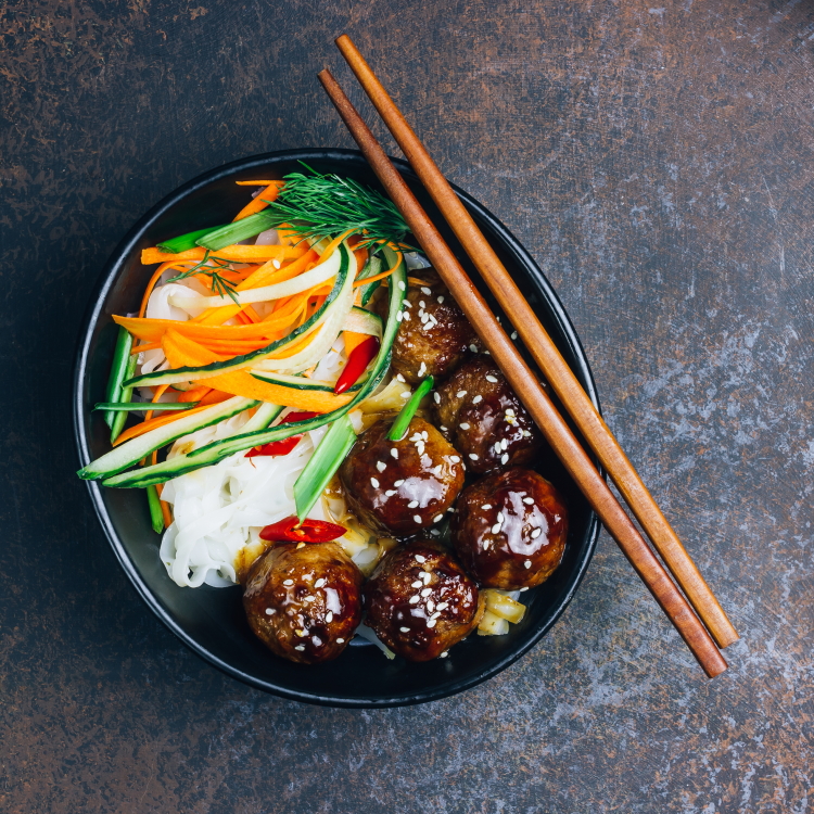 Ginger-Teriyaki Meatballs w/ rice noodles and vegetable garnish