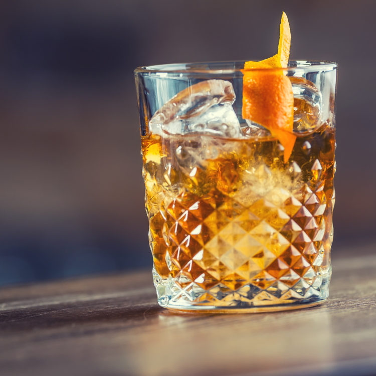 whiskey cocktail w/ orange twist garnish